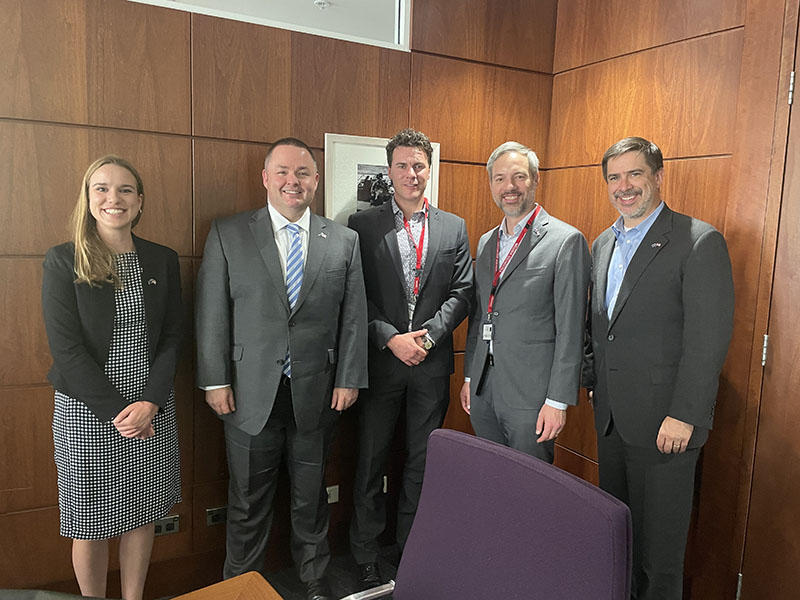 Commissioner Varilek stands for a picture with a group of four people.