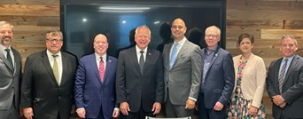 A picture of Governor Walz, Commissioner Varilek and Deputy Commissioner McKinnon standing with a group from Greenfield Global.