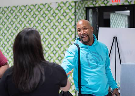 smiling man extending hand for a handshake